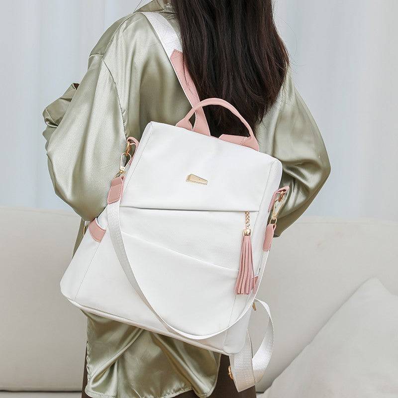 Oxford cloth stitching women's white backpack with pink accents, anti-theft back zipper, casual travel and school bag with double shoulder straps