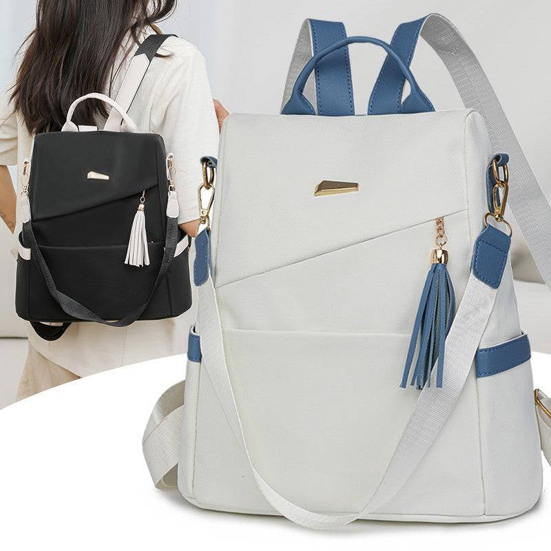 Oxford cloth stitching women's anti-theft backpack with tassel detail in black and white colors, casual travel and school bag