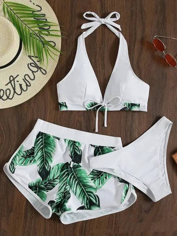 3-piece women's leaf print bikini set with halter top, white and green tropical design, and matching shorts and bottoms for summer beachwear