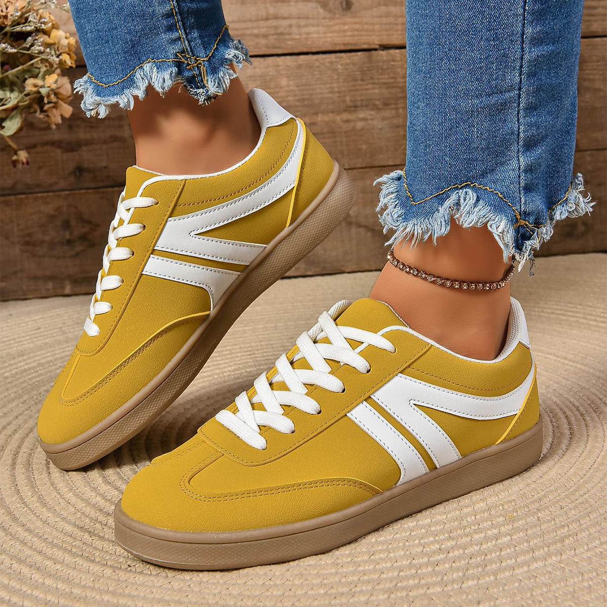 Yellow lace-up round toe flats shoes with white accents and casual sporty design for women