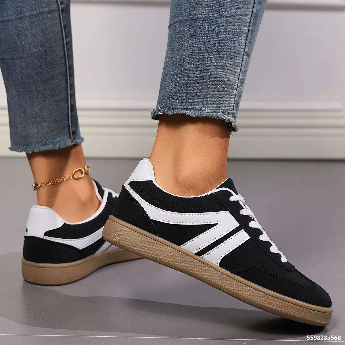 Black and white lace-up round toe flats shoes for women worn with jeans, casual slip-on style