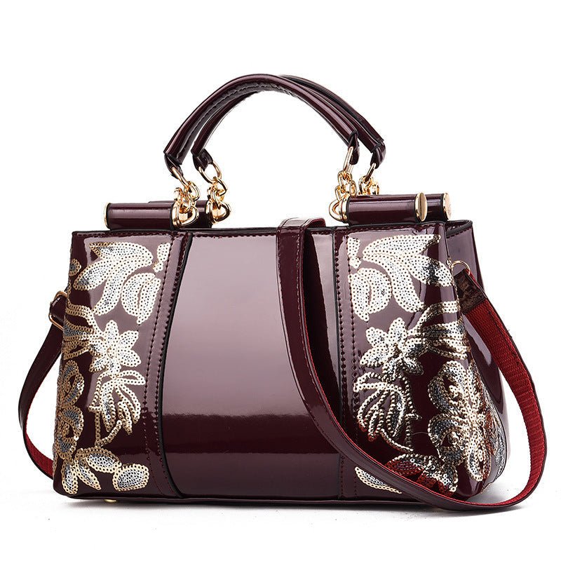 Elegant maroon fashion sequins handbag with floral embroidery and gold accents, suitable for party and wedding occasions
