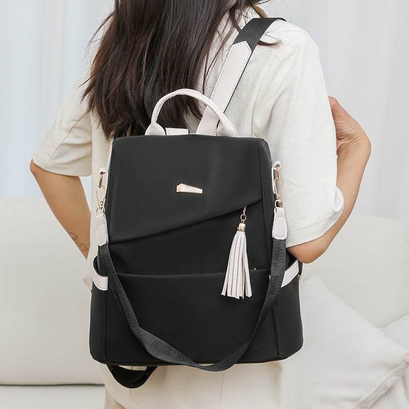 Oxford cloth stitching women's black backpack with anti-theft back zipper and tassel detail