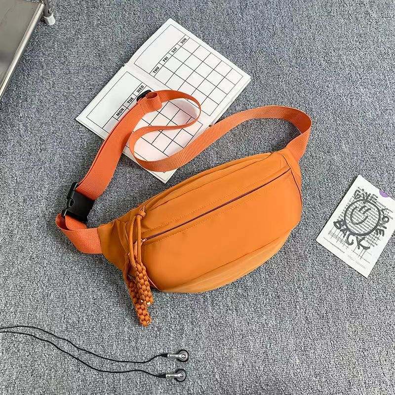 Men's small sports crossbody chest bag in orange polyester with adjustable strap