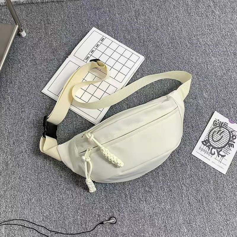 Men's small shoulder sports crossbody chest bag in milky white polyester with nylon lining.