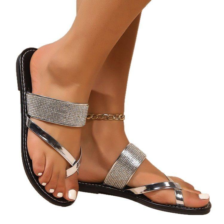 Black flat beach sandals with toe covering rhinestone straps and leather lining