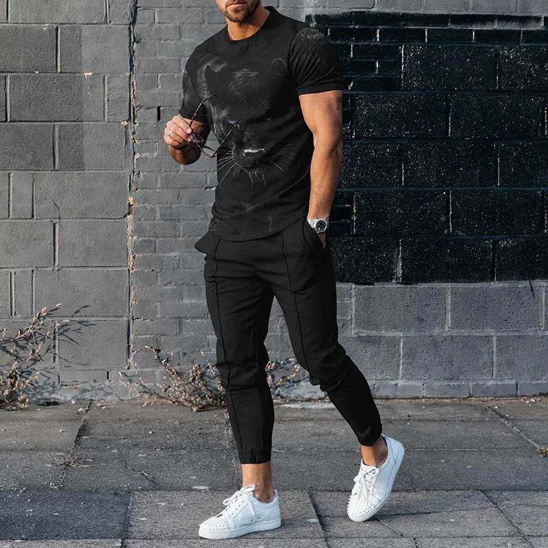 Man wearing short-sleeved cotton-like black printed pullover and black slim trousers with white sneakers on urban street