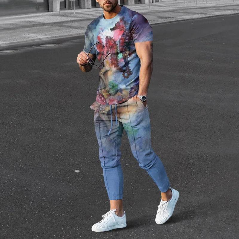 Man wearing short-sleeved cotton-like printed pullover and matching trousers set with colorful abstract design