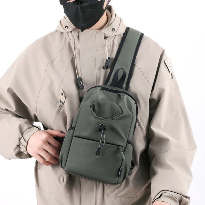 Waterproof Oxford cloth kettle bag in green worn as shoulder chest bag for men