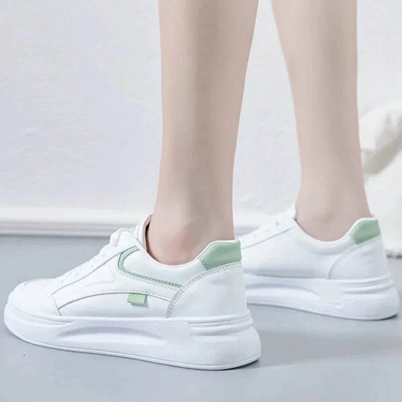 White women's fashion sneakers with green accents, lace-up casual trainers for comfort and stability