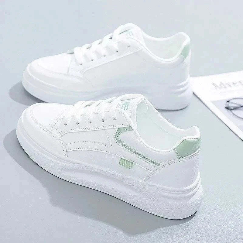 White women's lace-up sneakers with light green accents and thick rubber soles, casual and comfortable design for running and daily wear