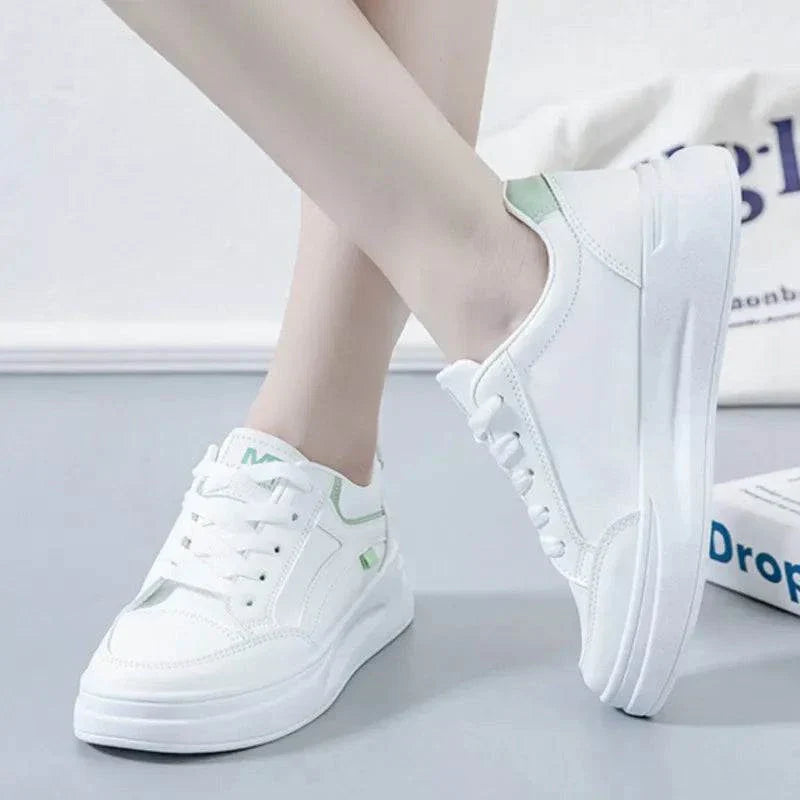 Women's white lace-up casual sneakers with green detail, platform sole, comfortable fit, suitable for hard court and running.