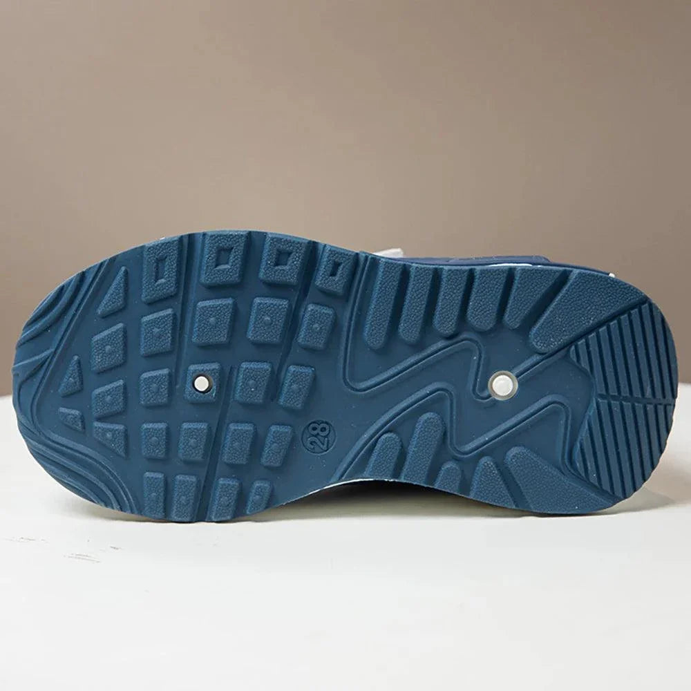 Bottom view of blue PU leather sport shoe sole for children with anti-slip EVA outsole design