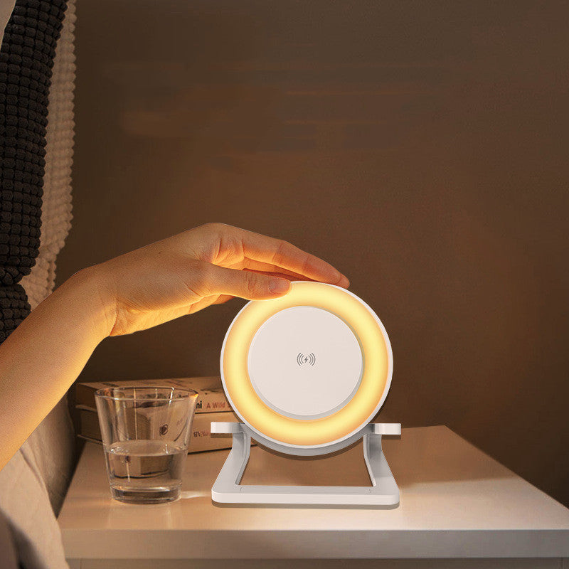 White Bluetooth speaker with wireless charging and ambient ring light on bedside table