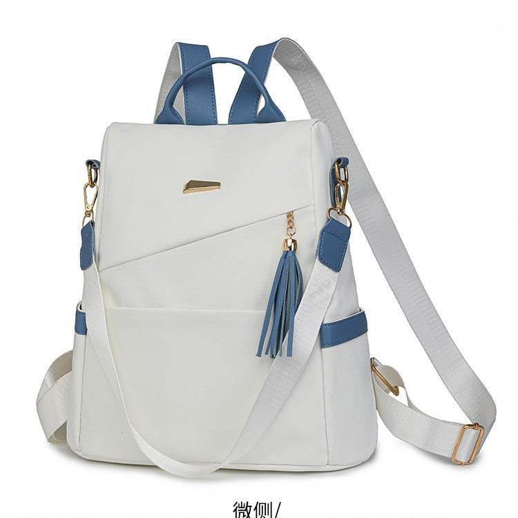 Oxford cloth stitching women’s backpack in white and blue with anti-theft back zipper and tassel detail, casual school and travel bag